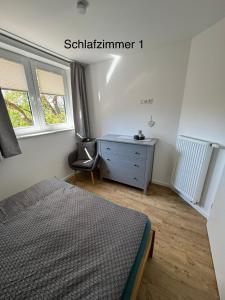 a bedroom with a bed and a desk and window at Brokeloh - Hier bin ich zuhause ! in Landesbergen