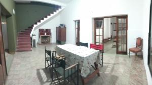 a dining room with a table and chairs and a staircase at SB hostel in La Rioja