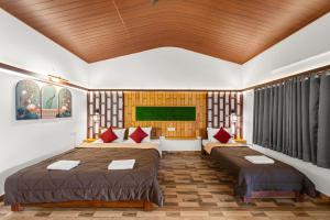 a bedroom with two beds in a room at Hatti Eden Coorg in Gonikoppal +44 photos