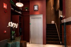 a white door in a red room with a staircase at Legazpi Doce Rooms & Suites in San Sebastián