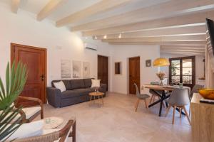 a living room with a couch and a table at Can Perla in Sóller