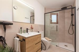 a bathroom with a shower and a sink and a toilet at Can Perla in Sóller +74 photos