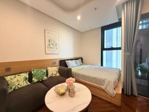 a living room with a couch and a bed at Mai home in Hai Phong +24 photos