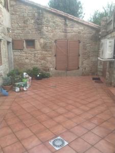 a patio in front of a stone building at Villa Careixo in Castro