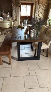 a wooden table with a vase on it in a room at Villa Careixo in Castro