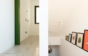 a hallway with art on the walls and a door at Duesette Rooms in Filottrano