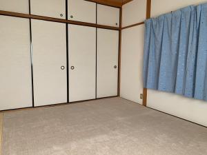 a room with white cabinets and a blue curtain at weiwei - Vacation STAY 08698v in Wakayama