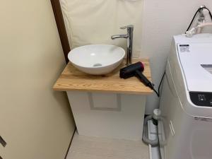 a bathroom with a white sink on a wooden counter at weiwei - Vacation STAY 08698v in Wakayama