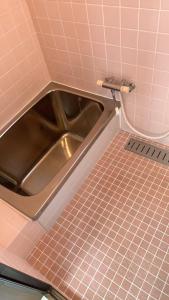 a metal sink in a bathroom with pink tiles at weiwei - Vacation STAY 08698v in Wakayama