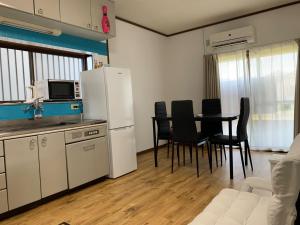 a kitchen with a table and chairs and a refrigerator at weiwei - Vacation STAY 08698v in Wakayama