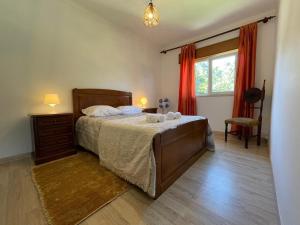 a bedroom with a bed and a dresser and a window at Geres - Gateway House - Terras de Bouro in Terras de Bouro +12 photos