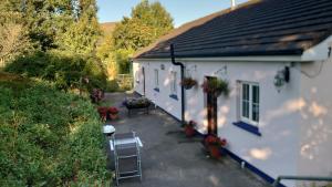 an aerial view of a white house with tables and chairs at Bleantis Mountain Cottage in the Comeragh Mountains in Dungarvan