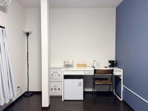 a kitchen with a desk with a chair and a table at D Hotel - Vacation STAY 89676v in Tokyo +15 photos