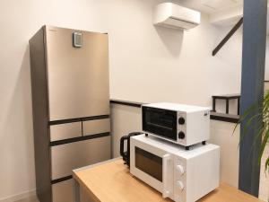a microwave on top of a computer on a desk at D Hotel - Vacation STAY 89676v in Tokyo