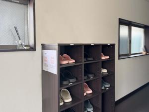 a shelf of shoes in a room with a mirror at D Hotel - Vacation STAY 89676v in Tokyo