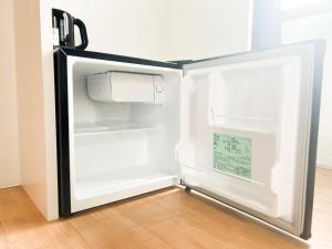 an empty refrigerator with its door open in a room at D Hotel - Vacation STAY 14103v in Tokyo
