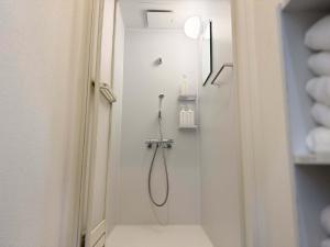 a shower in a white bathroom with a shower at D Hotel - Vacation STAY 14103v in Tokyo