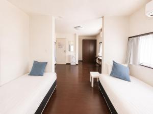 a room with two beds and a hallway at D Hotel - Vacation STAY 78387v in Tokyo