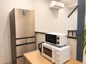 a microwave on top of a computer on a desk at D Hotel - Vacation STAY 78387v in Tokyo