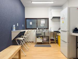 a kitchen with a counter and a sink and a refrigerator at D Hotel - Vacation STAY 89642v in Tokyo