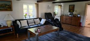 a living room with a couch and a coffee table at Cozy House in Albertslund