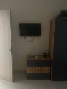 a room with a tv on the corner of a wall at Stella Apartment in Nikiti