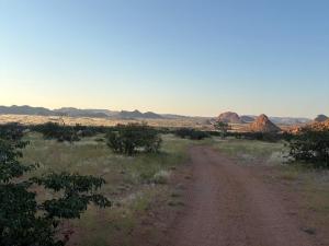 a dirt road in the middle of the desert at Sky and Stone Tented Camps in Twyfelfontein
