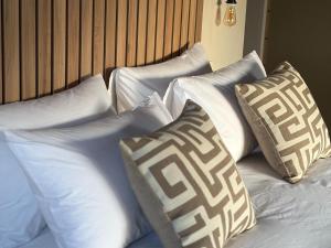 a group of pillows on a bed in a room at Sky and Stone Tented Camps in Twyfelfontein