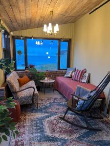 a living room with a bed and a couch at NEW house by the beach in Andøya