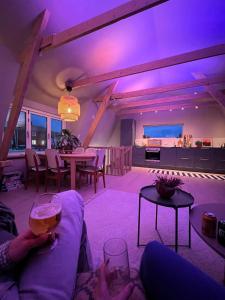a person sitting on a couch with a wine glass at NEW house by the beach in Andøya +33 photos