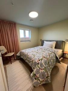 a bedroom with a bed with a quilt on it at NEW house by the beach in Andøya