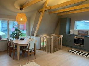 a kitchen and dining room with a table and chairs at NEW house by the beach in Andøya