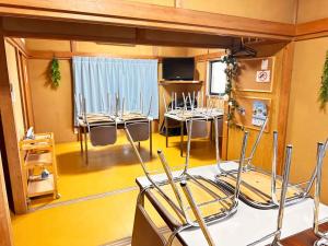 a room with chairs and tables in a room at kupono - Vacation STAY 00621v in Minamiboso