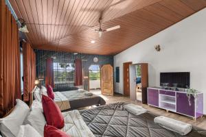 a bedroom with two beds and a couch at Hatti Eden Coorg in Gonikoppal