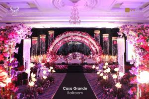 a banquet hall with pink flowers and a chandelier at Merlynn Park Hotel in Jakarta +61 photos