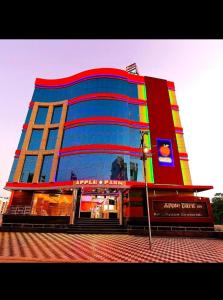 a large building with a sign in front of it at Hotel Apple Park Inn in Tiruchirappalli