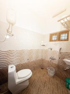 a bathroom with a toilet and a shower at Mist & Meadows Premium VIlla By STAYVA in Munnar