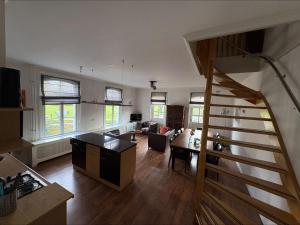 a living room with a staircase and a living room at Hampshire Hotel - Avenarius in Ruurlo