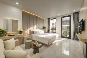 a hotel room with a bed and a couch at A89 West Lake Hotel in Hanoi