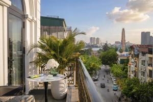 a balcony with a table and a view of a city at A89 West Lake Hotel in Hanoi