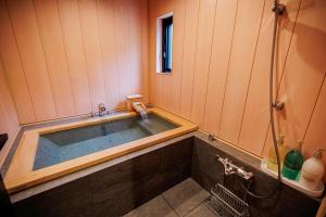 a bath tub in a bathroom with a shower at Sunlight - Vacation STAY 73377v in To-katta +15 photos
