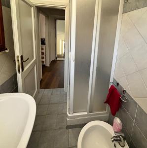 a bathroom with a shower and a toilet and a sink at Bilocale con terrazzo in centro storico in Dorgali