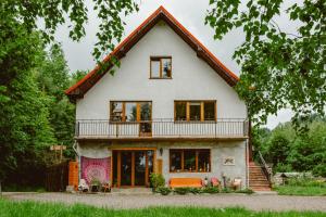a large white house with a large balcony at DobroDziejnia in Nowa Ruda