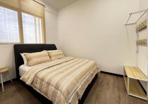 a bedroom with a bed and a window at MySky Putrajaya in Putrajaya