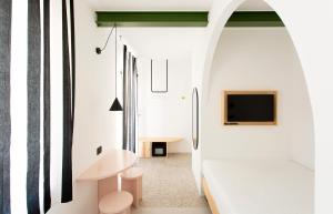 a room with a hallway with white walls and a mirror at Duesette Rooms in Filottrano