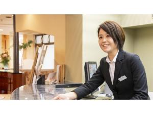 a woman sitting at a desk in an office at Hotel Symphony - Vacation STAY 48769v in Sagae +36 photos
