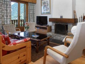 a living room with a couch and a fireplace at Apartment Baudrier A28 by Interhome in Verbier