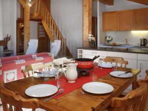 a wooden table with plates and glasses on it in a kitchen at Apartment Baudrier A28 by Interhome in Verbier