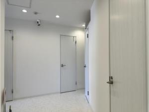 a corridor with white walls and doors in a room at Monarch Hotel - Vacation STAY 43022v in Otaru
