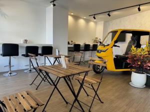 a yellow scooter parked in a room with tables and chairs at Monarch Hotel - Vacation STAY 43022v in Otaru +1 photo